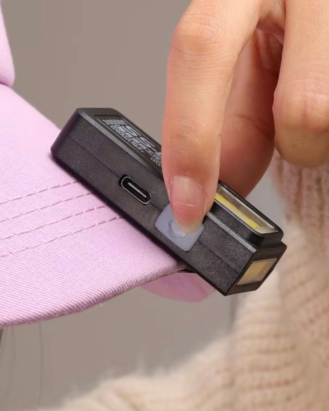 Vellcom™ Mini Clip-On COB Rechargeable Light clipped to a hat brim
